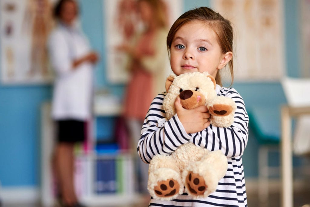 Young girl holding a teddy bear not concerned about calcium disorders after treatment from Dr. Josua Smith, the region's only pediatric endocrinologist in Idaho Falls and Pocatello.