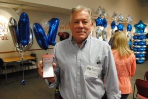 A man holding his recognition award.