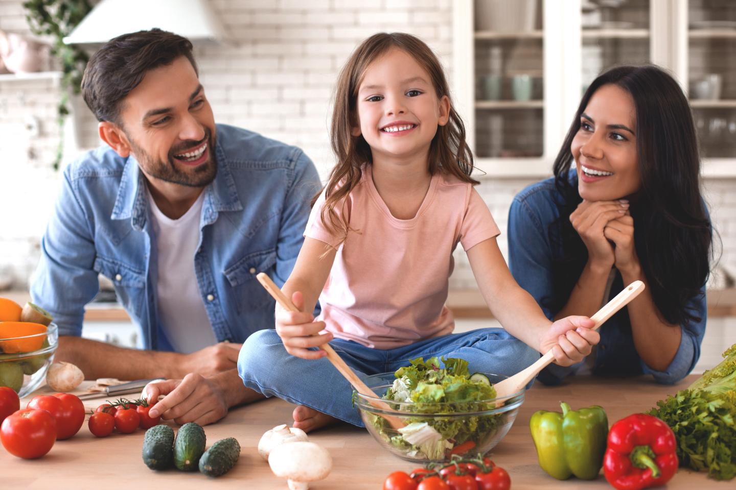 Family preparing a healhty salad for dinner