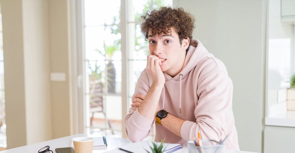 Teenage boy sitting at counter after gynecomastia treatment by Dr. Joshua Smith, a pediatric endocrinologist in Pocatello and Idaho Falls.