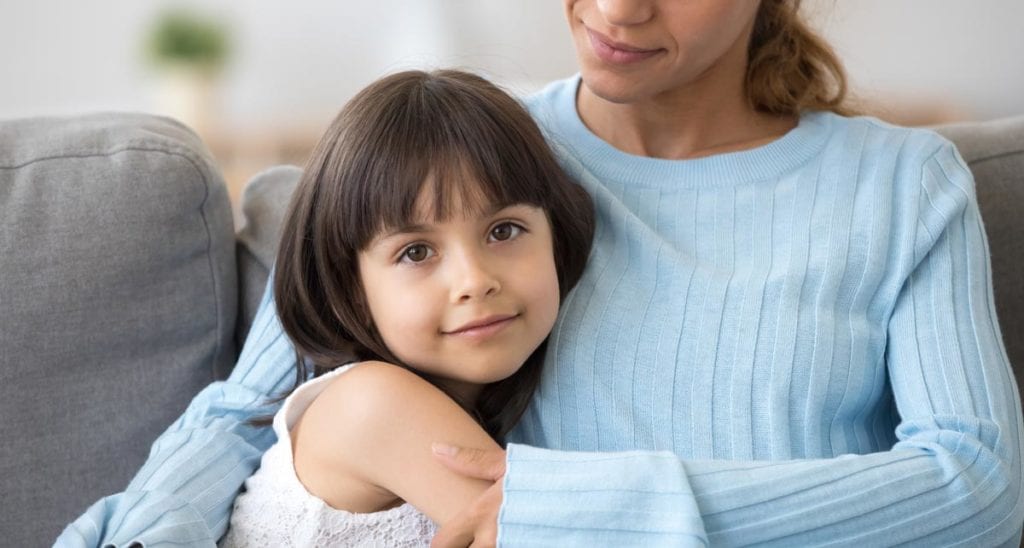 Mother with arms around a young child after pituitary gland treatment by Dr. Joshua Smith, a pediatric endocrinologist in Pocatello and Idaho Falls.
