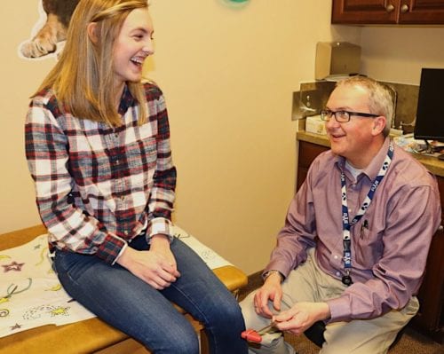 Dr. Joshua Smith talks with a young patient about pediatric thyroid gland problems treated by this pediatric endocrinologist in Pocatello and Idaho Falls.