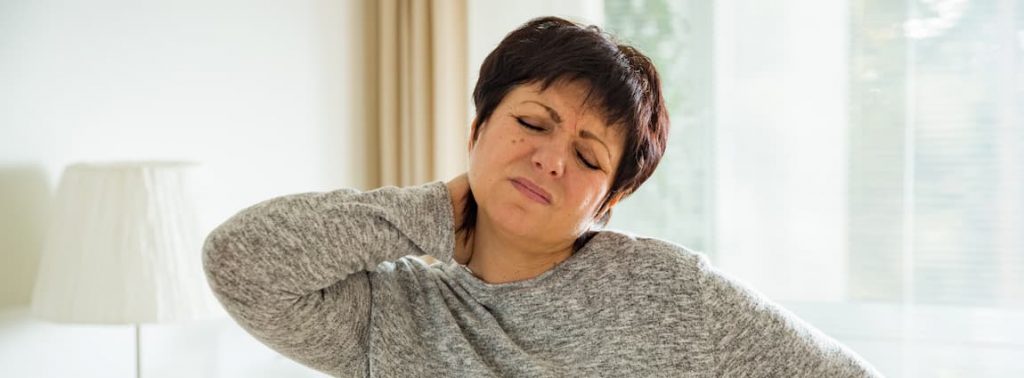 Woman holding her neck because she has a calcium disorder and needs to see our endocrinology specialist doctor in Idaho Falls or Pocatello.