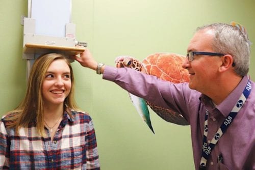 Youg girl being measured by pediatric endocrinologist doctor Joshua Smith a diabetes doctor in Idaho Falls and Pocatello.