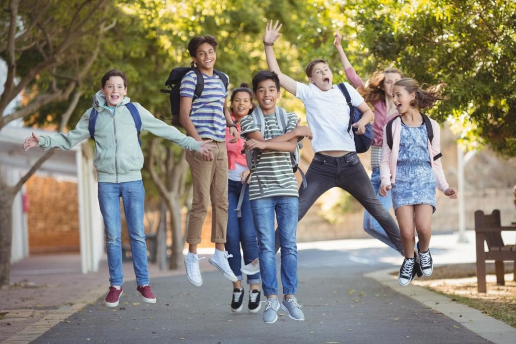 A group of young teenagers jumping due to early or delayed puberty symptoms being treatment by Dr. Joshua Smith, a pediatric endocrinologist in Pocatello and Idaho Falls.