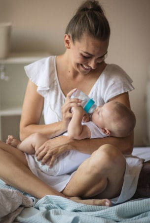 Parent feeding a baby.