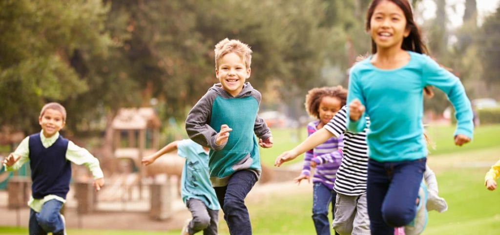 Children running in park after getting a thyriod exam from pediatric endocrinologist, Dr. Josua Smith, with offices in Idaho Falls and Pocatello.