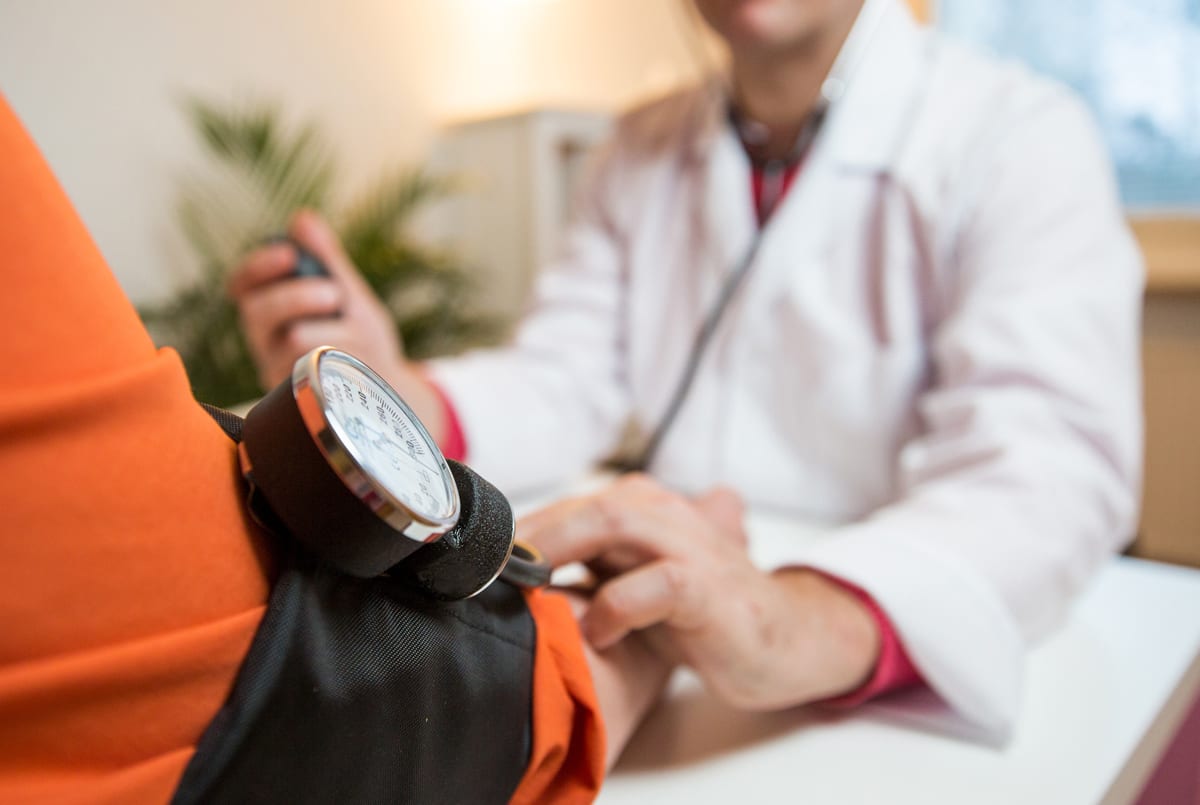 A diabetes doctor in Idaho Falls or Pocatello taking blood pressure of a patient of Rocky Mountain Diabetes center.