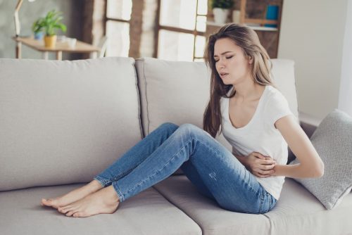 A woman suffering from period cramps needing an endocrinology specialist in Idaho Falls or Pocatello.