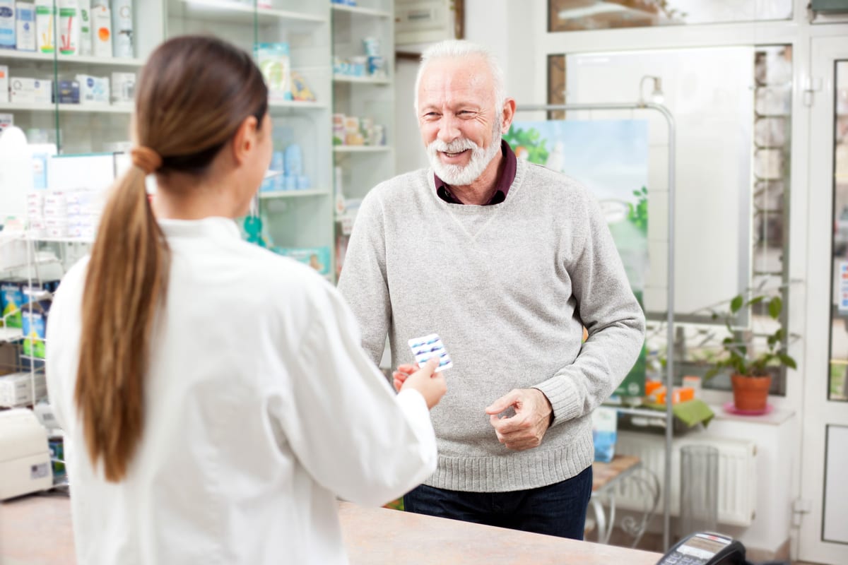 An elderly man talking with a pharmacist about diabetes medication prescribed by his diabetes doctor in Idaho Falls or Pocatello. 