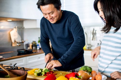 Husband and wife with insulin resistance and prediabetes making a healthy meal as directed by one of our diabetes doctors In Idaho Falls or Pocatello.