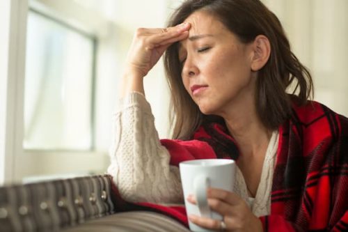 Woman with a headache, one of many symptoms of hypertension, which is treated by our endocrinologists in Idaho Falls and Pocatello.