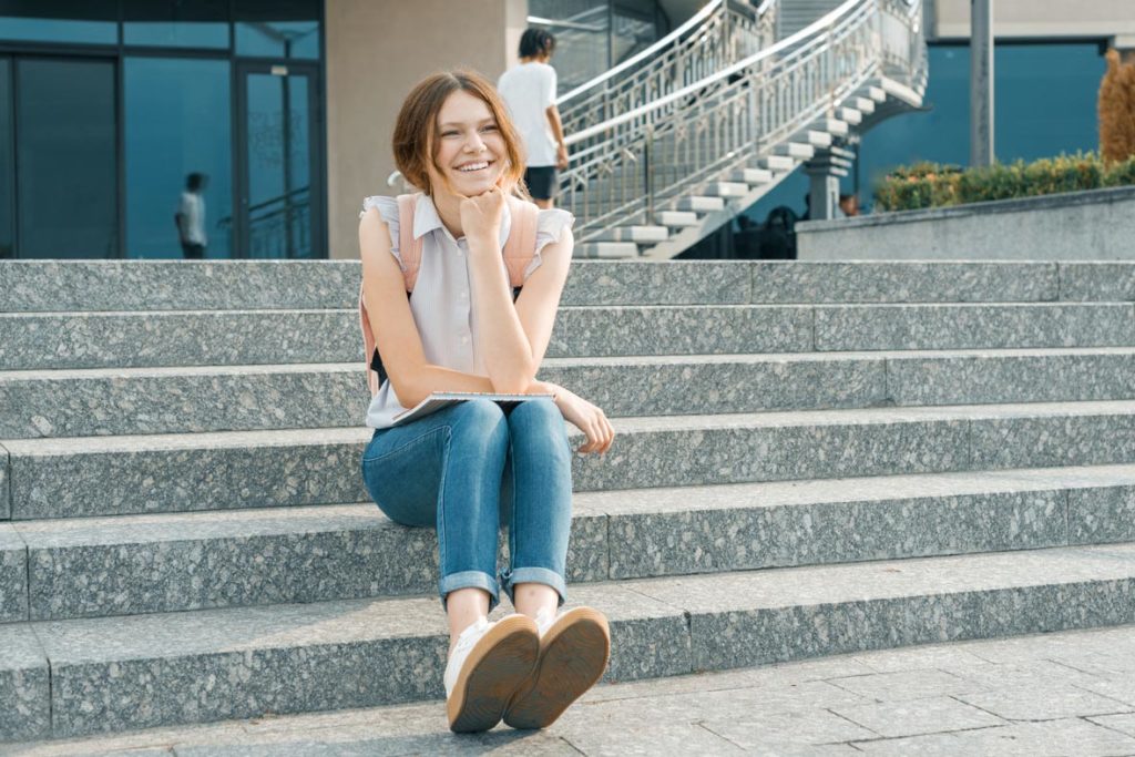 Tall girl sitting on steps after a tall stature treatment by Dr. Joshua Smith, a pediatric endocrinologist in Pocatello and Idaho Falls.