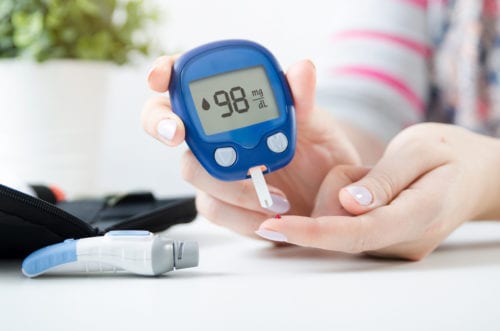 Blood reading fingerstick read by woman with type 2 diabetes seeing one of our diabetes doctors In Idaho Falls or Pocatello.