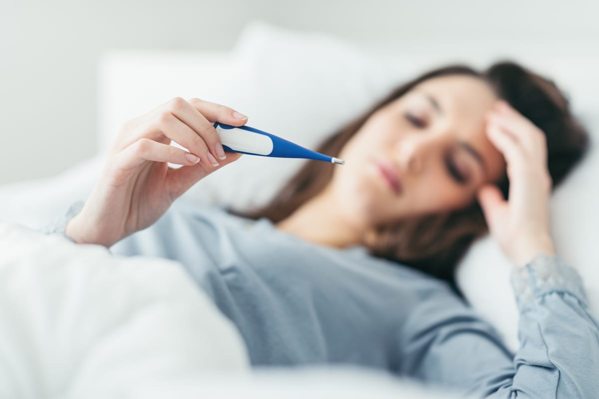 Ill woman looking at thermometer, a patient of Rocky Mountain Diabetes center in Idaho Falls and Pocatello.