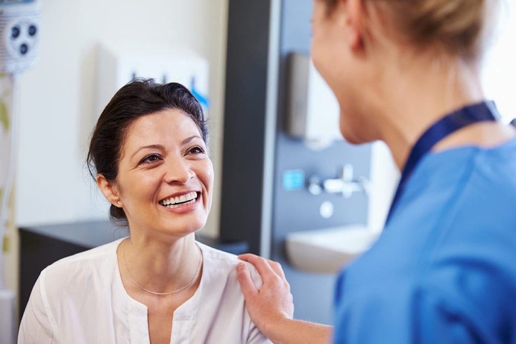 A caring clinical research staff member talking to a patient involved in a clinical study as part of our endocrine specialty and diabetes doctor care in Idaho Falls and Pocatello.